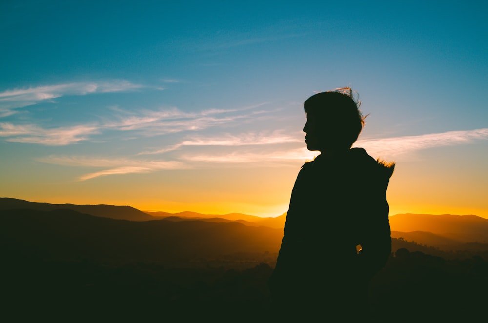 silhouette of person under blue sky