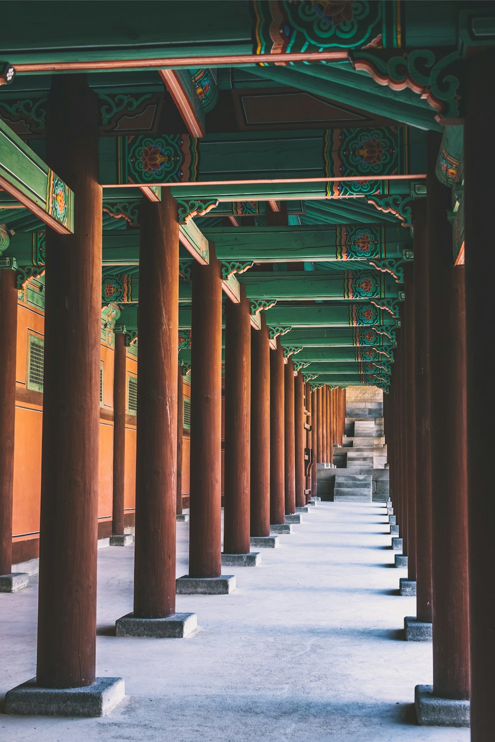 brown wooden post temple with green roof photo during daytime