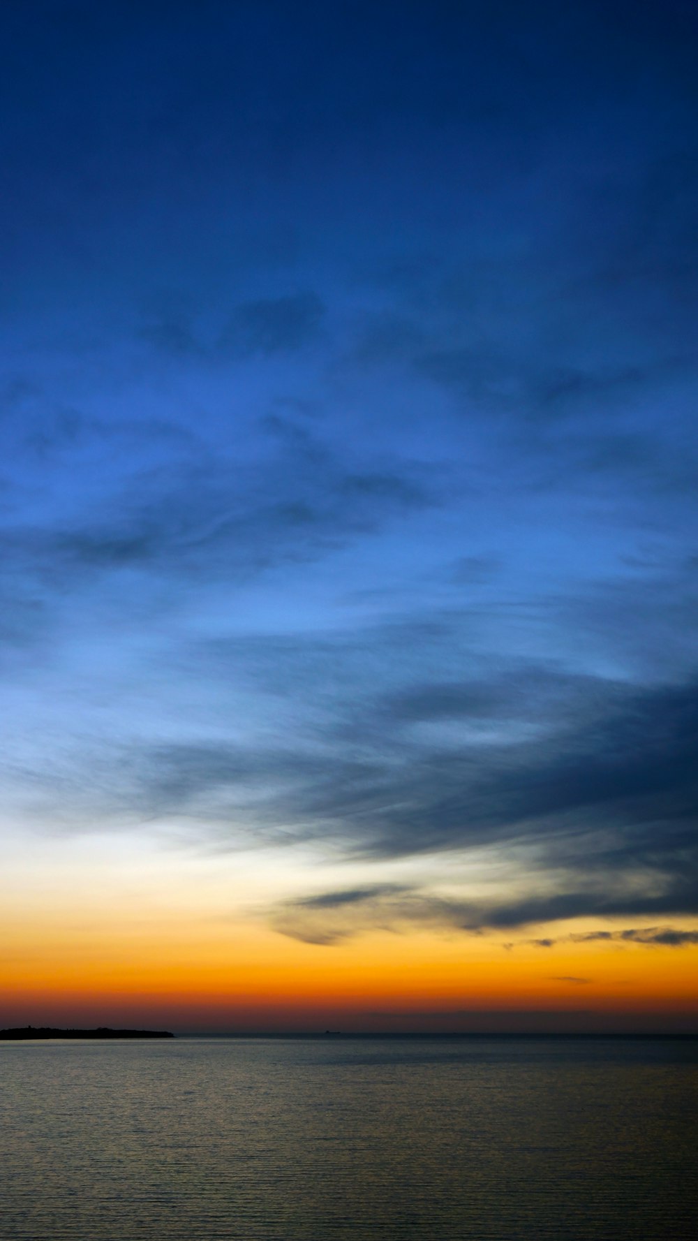 body of water under blue sky