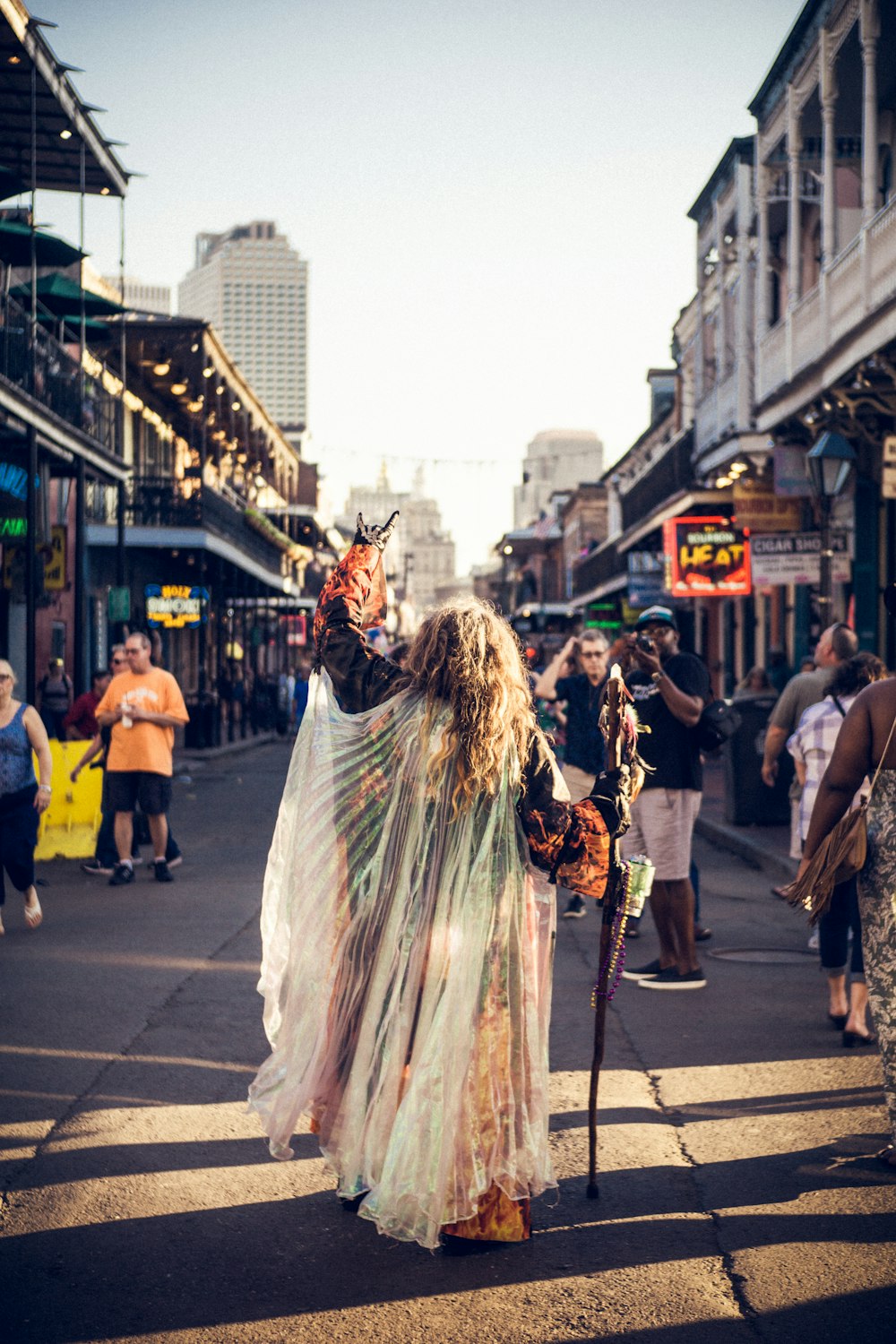 person raising mask on street