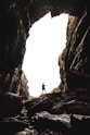 man standing on cave