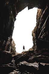 man standing on cave