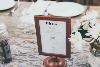 Menu-printed board with brown frame on table