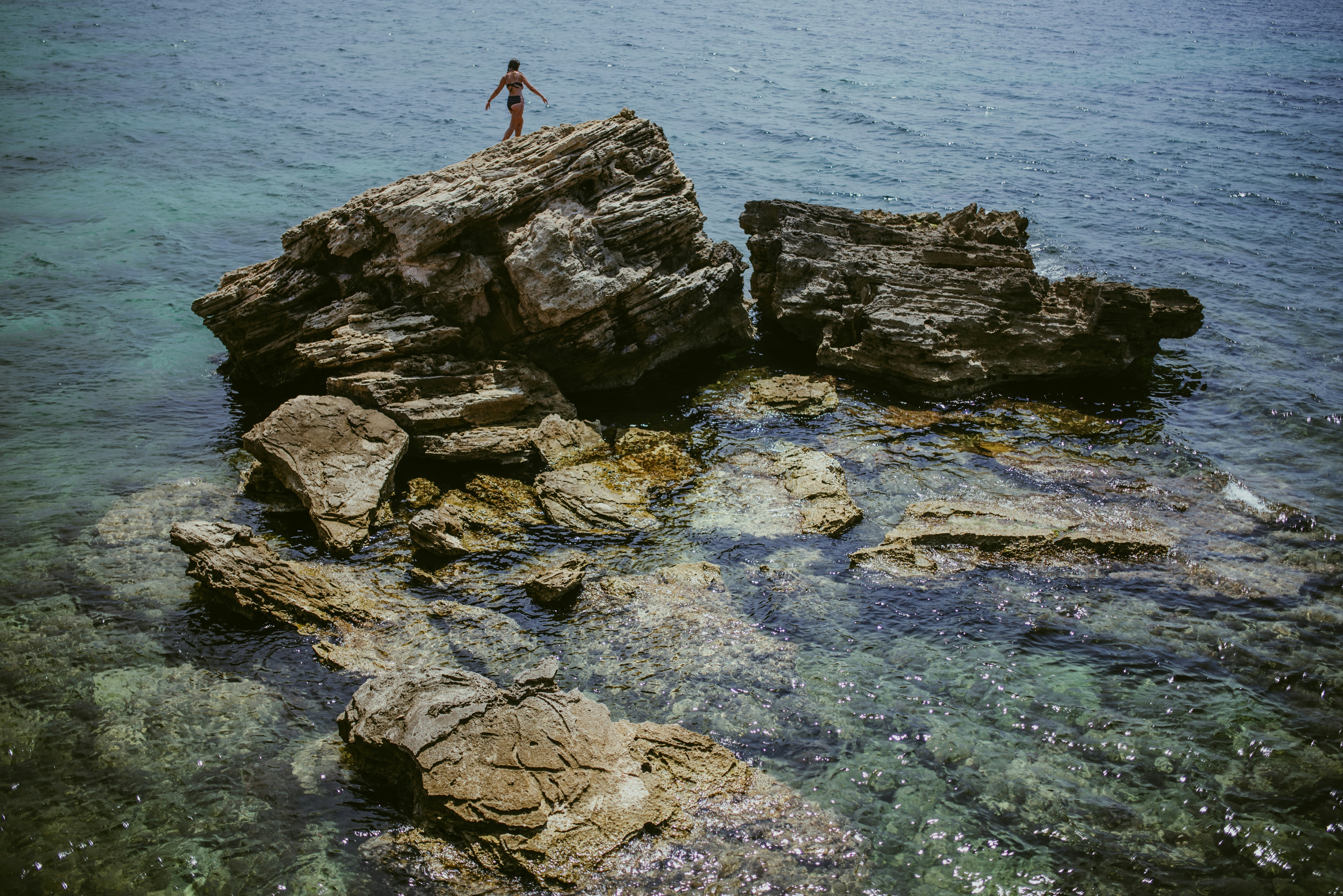 person standing on rock formation