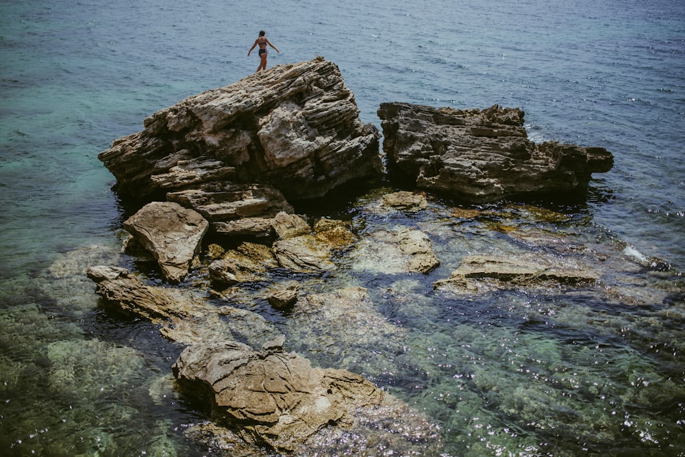 person standing on rock formation