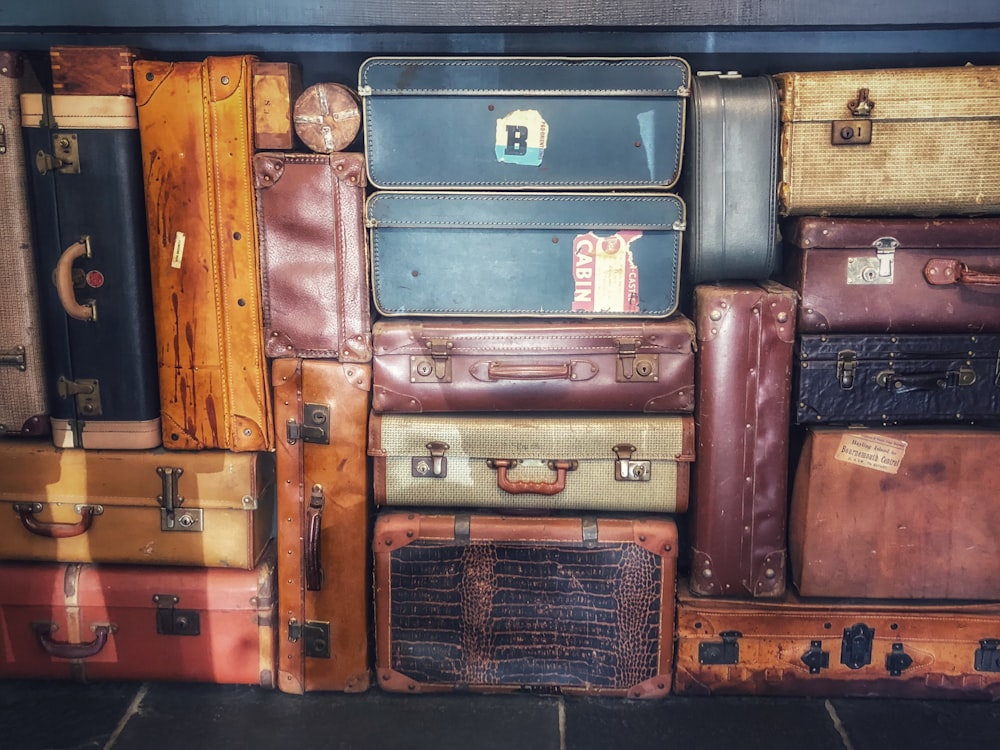 low light photography of stacked luggage