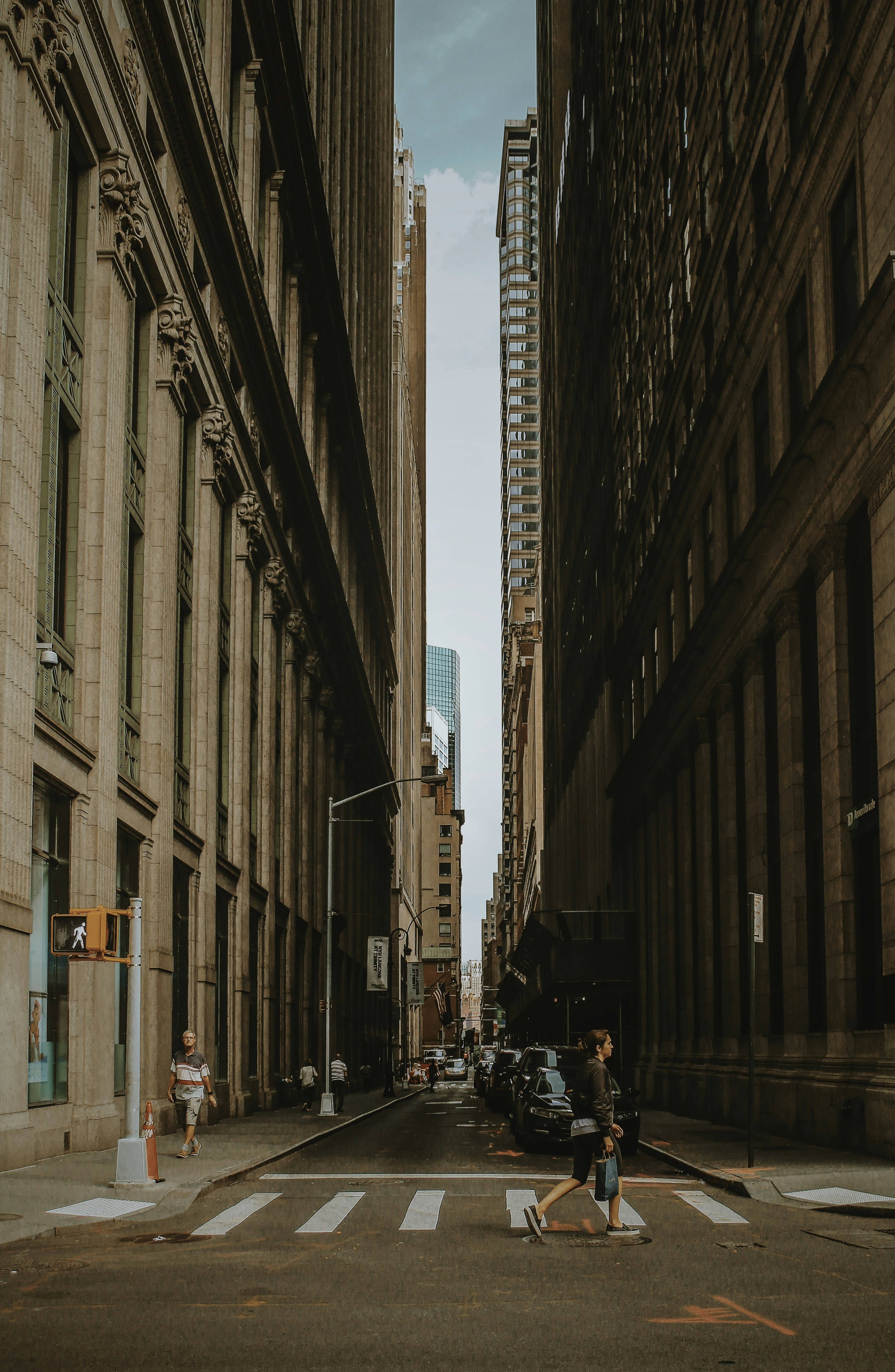 Woman Walking On Street Between Building During Daytime Photo Free New York Image On Unsplash