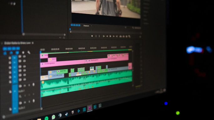 A sleek editing timeline with clips and color-coded tracks glowing softly against a dark background.