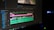 A computer screen displays a video editing software interface with multiple tracks visible in the timeline. The timeline includes video and audio tracks, colored in pink, green, and blue, indicating different layers or elements. The software has various tools and menus around the timeline.