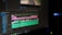 A computer screen displays a video editing software interface with multiple tracks visible in the timeline. The timeline includes video and audio tracks, colored in pink, green, and blue, indicating different layers or elements. The software has various tools and menus around the timeline.