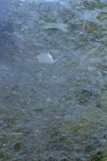 Close-up of graphene-based polymer composite showing intricate microscopic structure with blue and green hues.