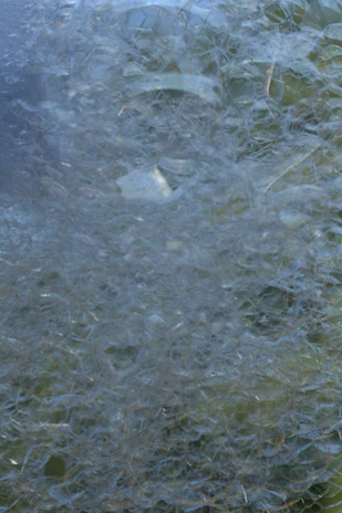 Close-up of graphene-based polymer composite showing intricate microscopic structure with blue and green hues.