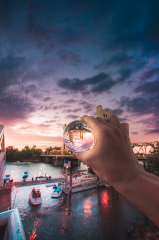 person holding crystal with reflected boat in Sacramento United States