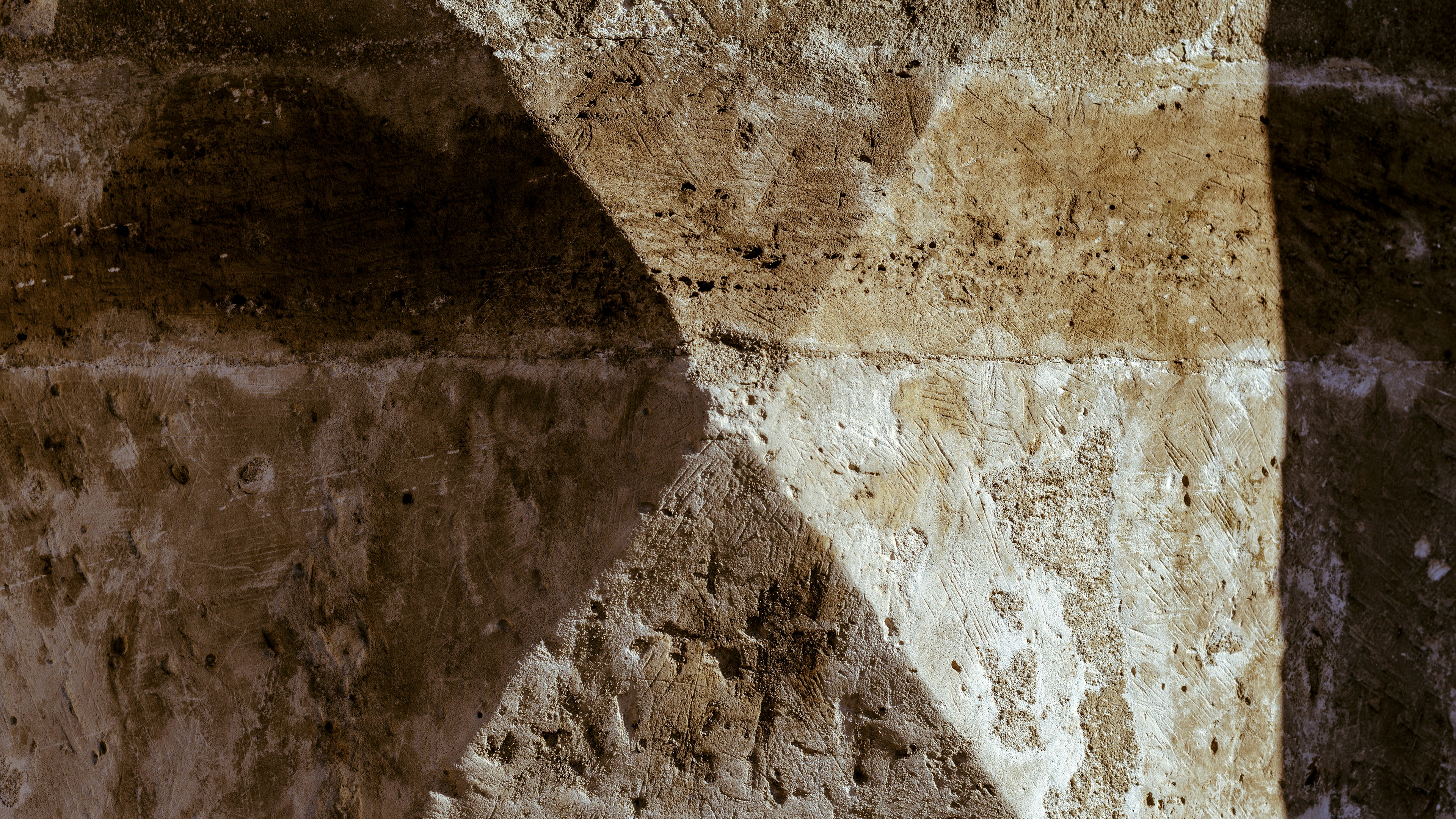 Luxury printed business materials on stone surface with deep shadows and directional light