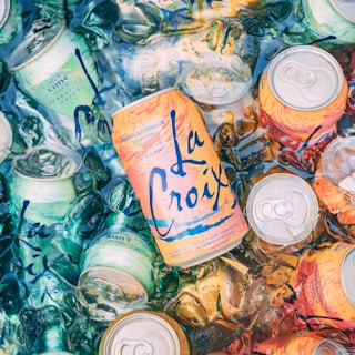 top view photography of orange steel soda can lot