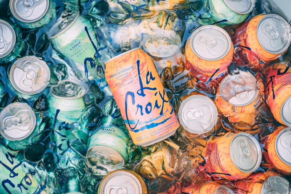 top view photography of orange steel soda can lot