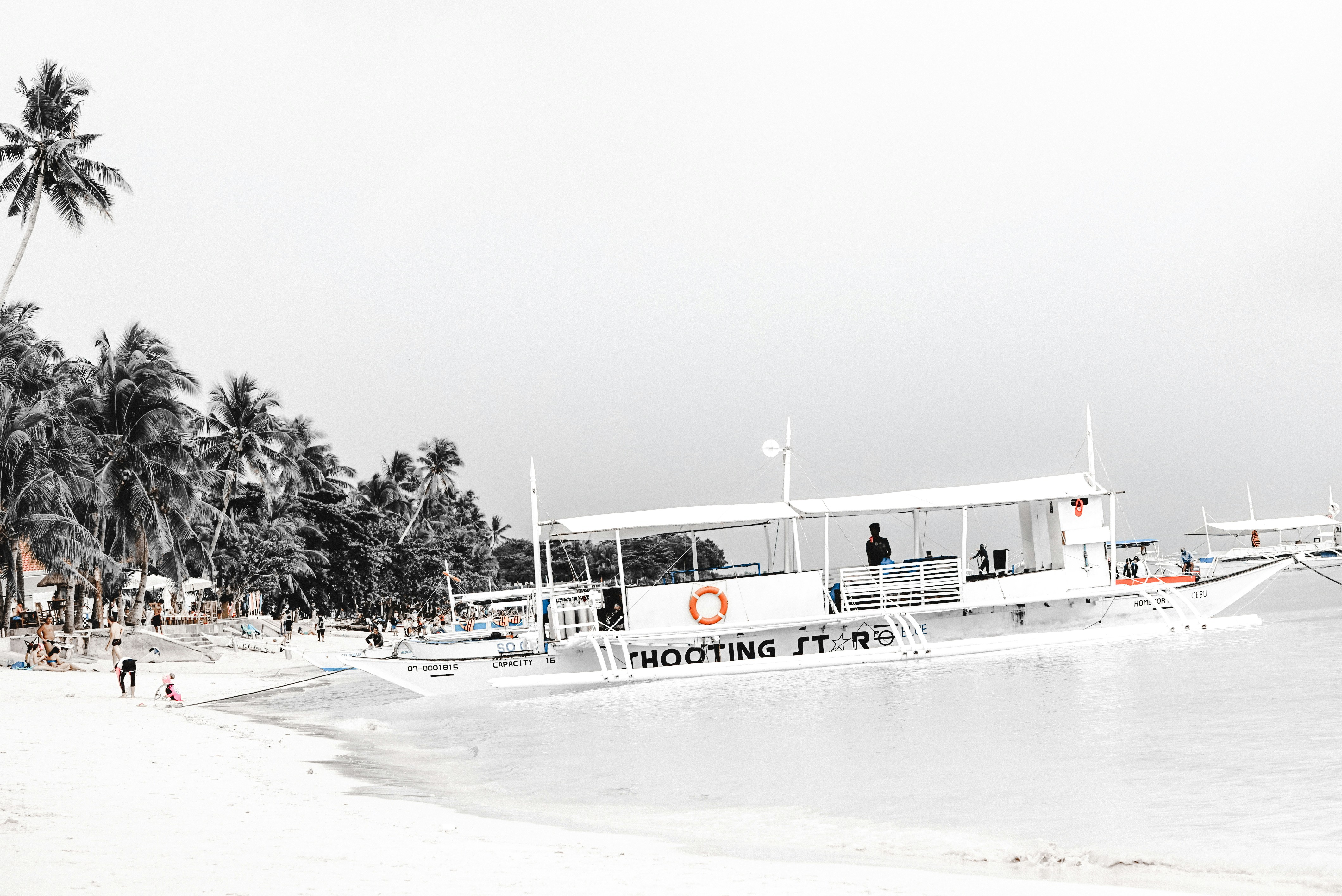 white boat near seashore
