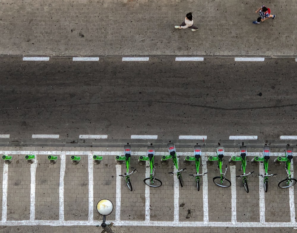 aerial photo of bicycles park on concrete pavement