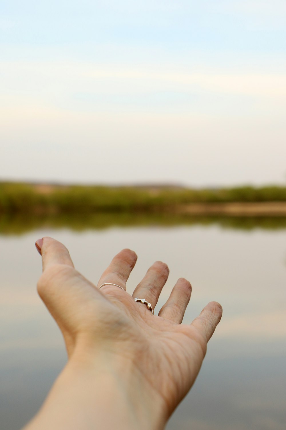 person wearing silver-colored ring