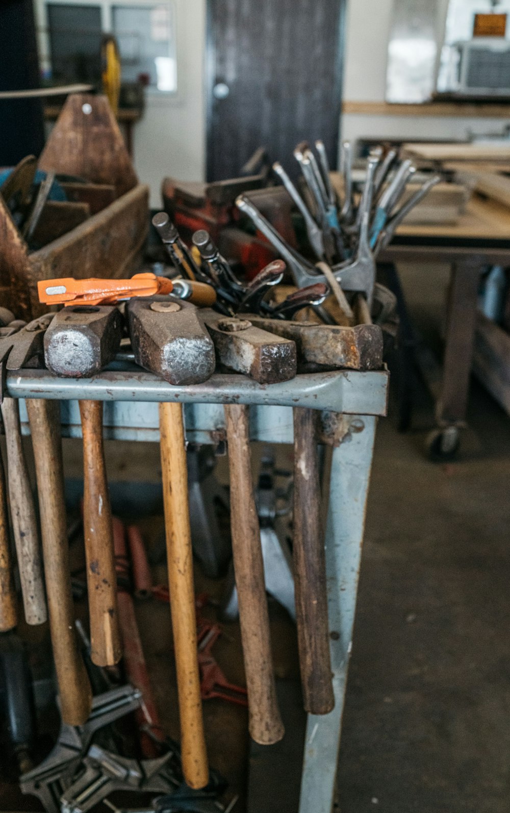 several handheld tools on metal rack