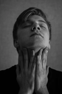 A serene close-up of a person gently touching their throat, expressing relief and calm.