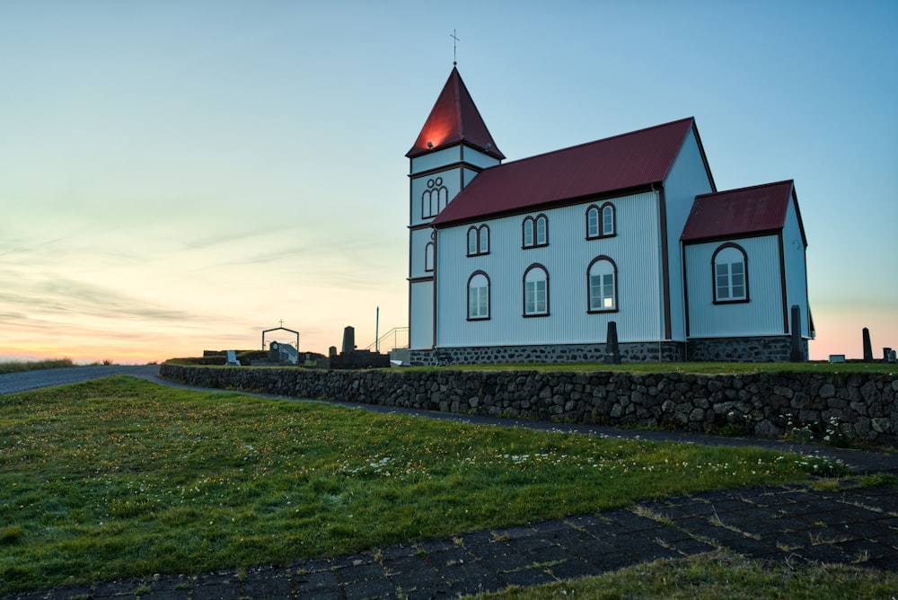 brown and red wooden house near green grasses at blue hour