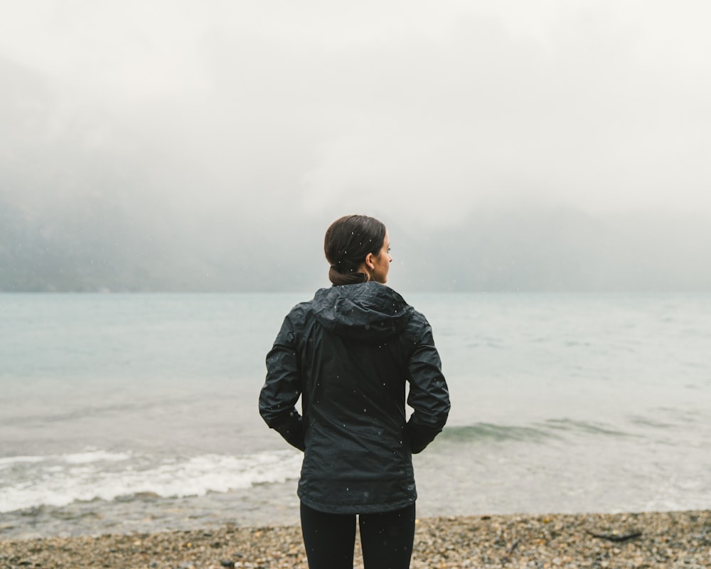 woman facing body of water