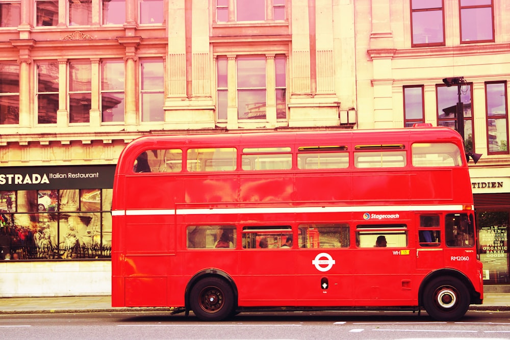 red double deck bus in front of building