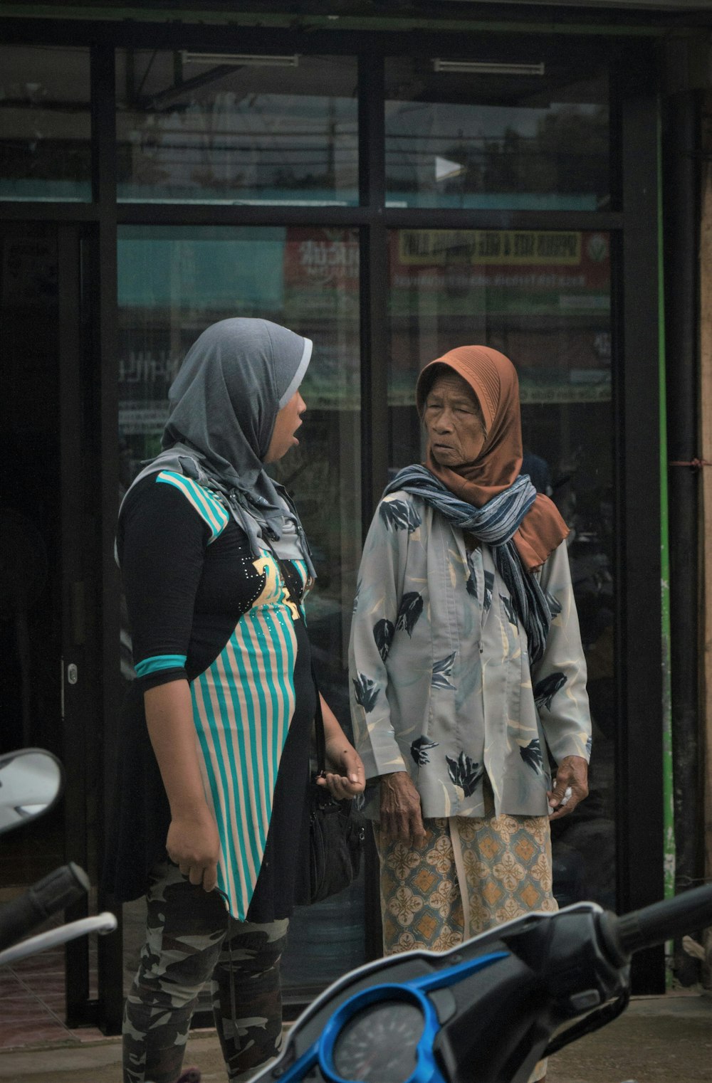 two person having conversation near glass door