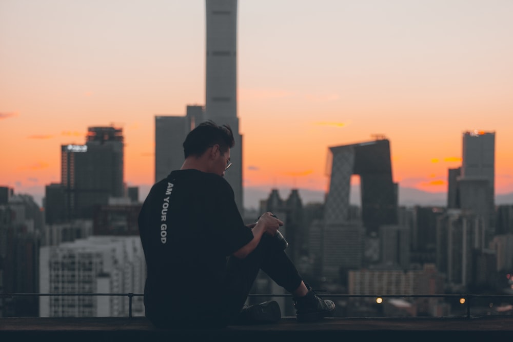 man sitting on building