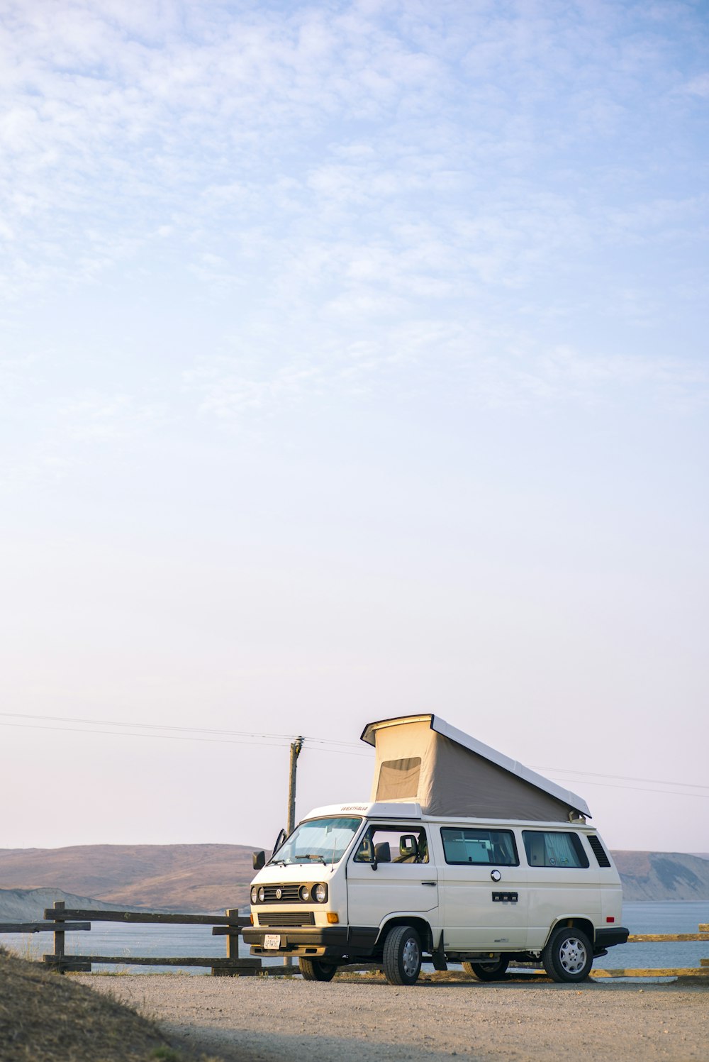 white van on brown soil at day time