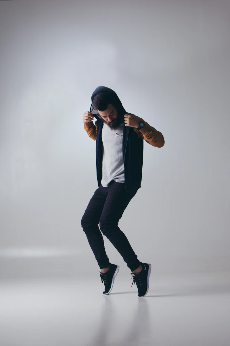 A jazz dancer leaping with arms extended in a bright studio