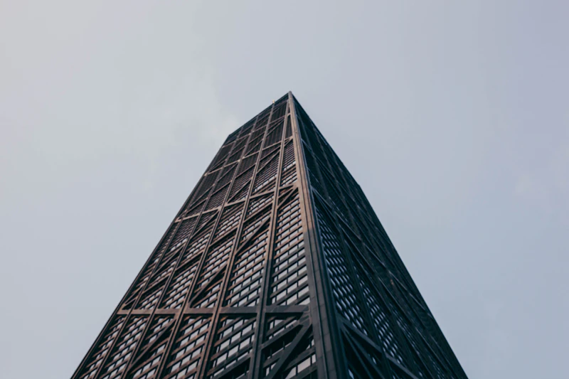 Low-angle view of the John Hancock Center's distinctive X-braced facade, home of 360 CHICAGO