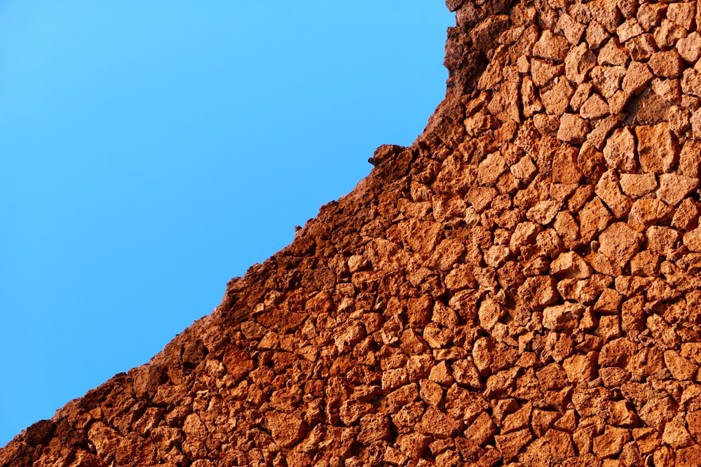 a stone wall with a blue sky in the background