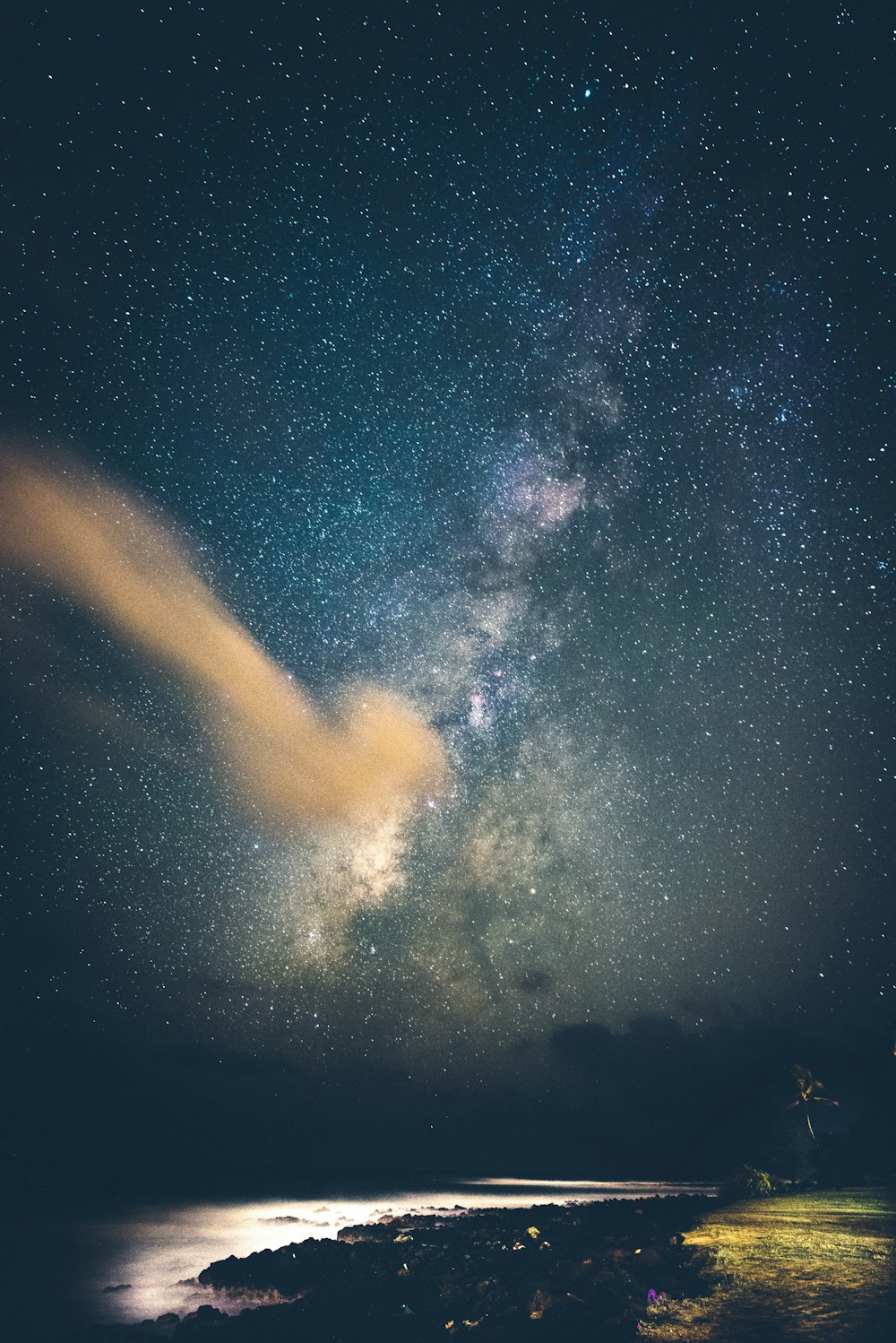 seashore under milky way