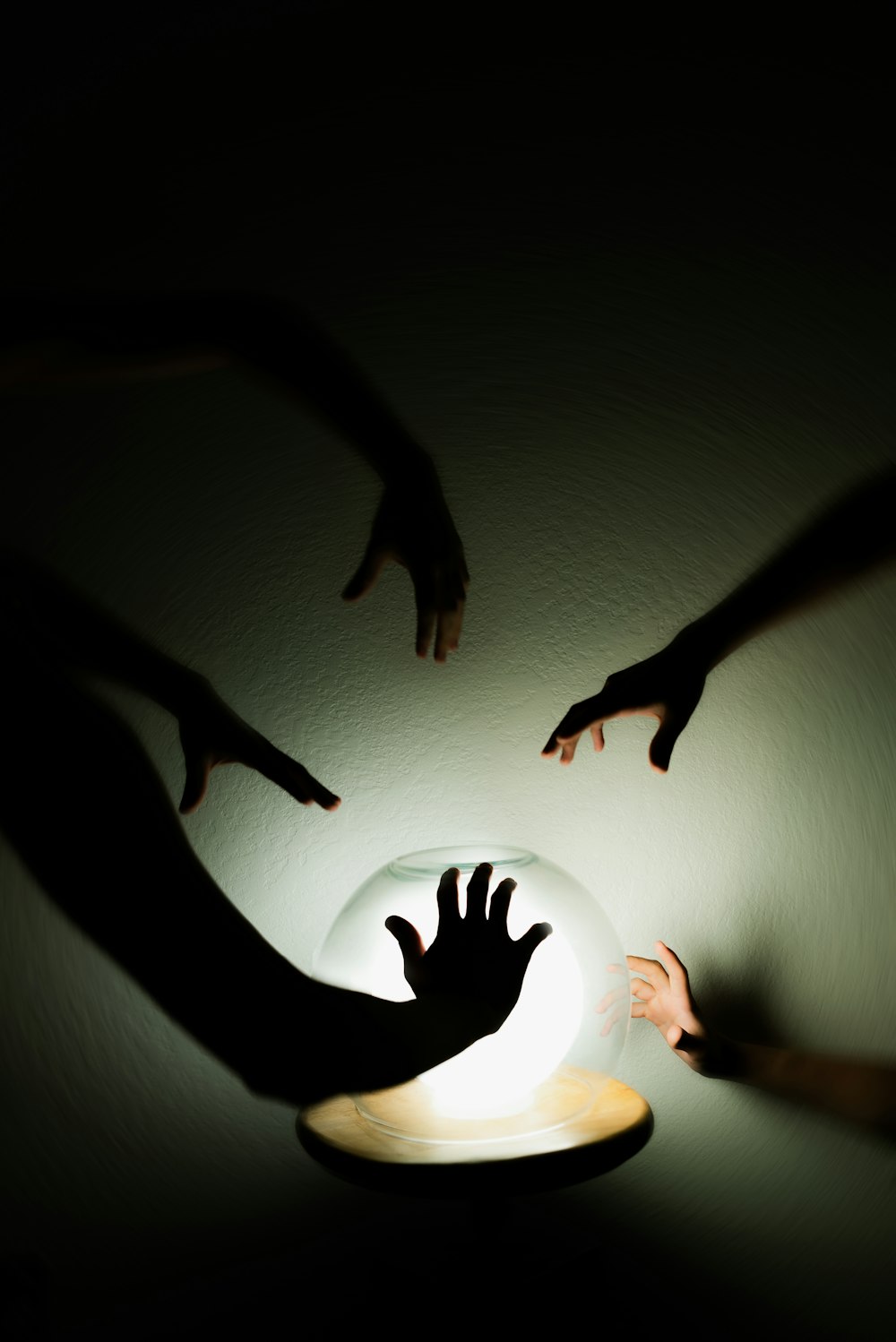 a group of people reaching for a light in the dark