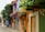 A couple exploring a vibrant city street filled with colorful buildings and lively atmosphere.
