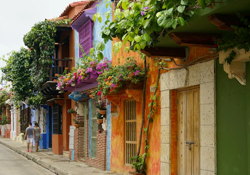 A joyful family exploring colorful streets of Buenos Aires under a bright blue sky.
