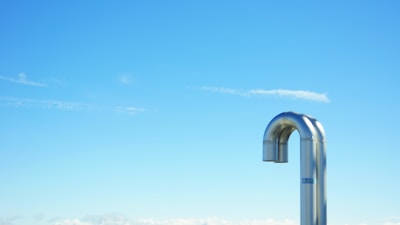 Close-up of a clean, freshly serviced dryer vent pipe with sunlight shining through.