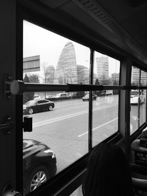 A modern bus driving through Abu Dhabi city streets during daytime.