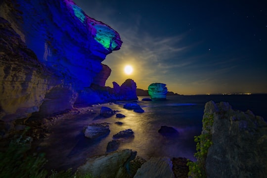 body of water with large rock digital wallpaper in Bonifacio France