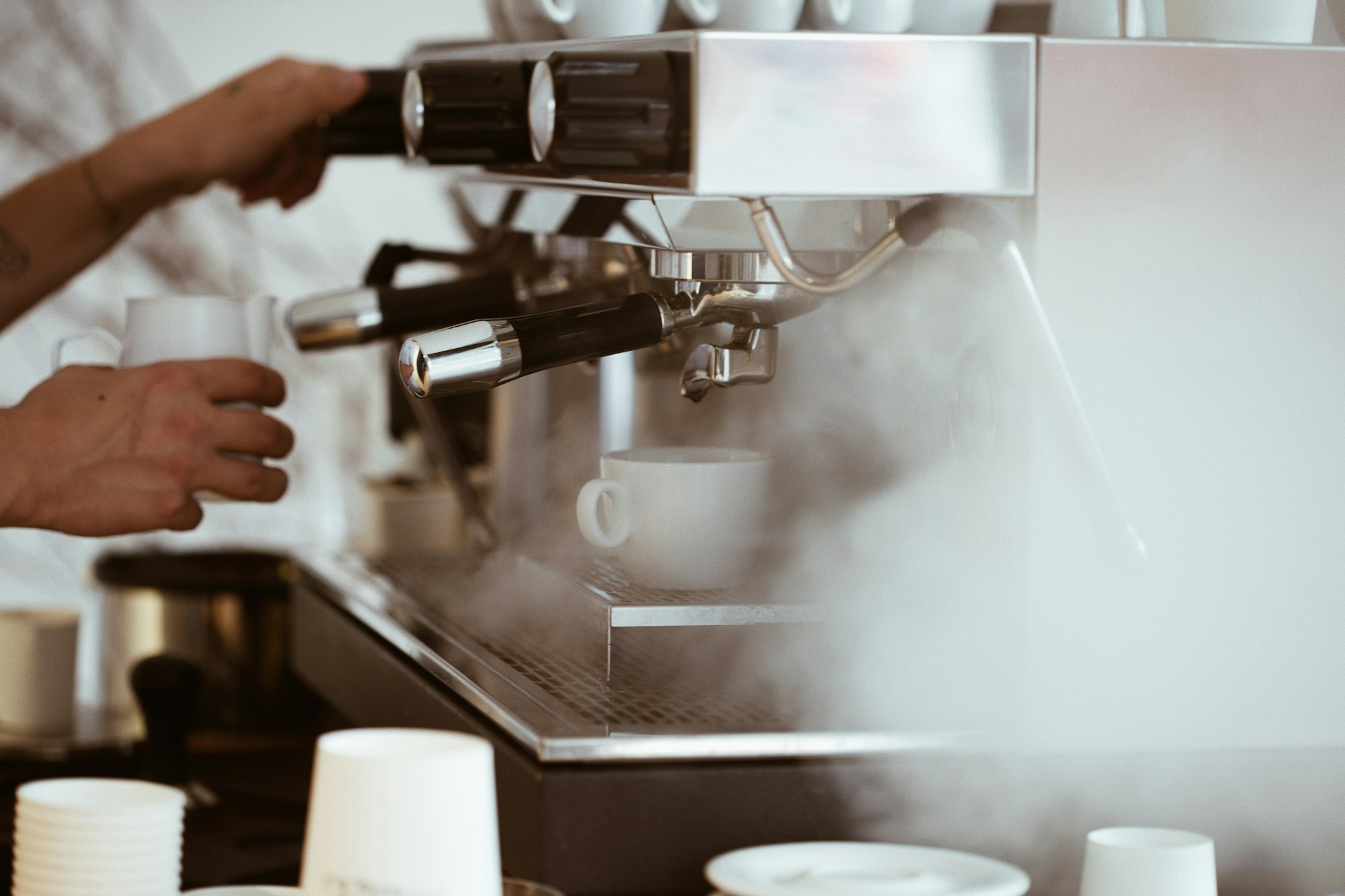 A barista learning how to use an espresso machine
