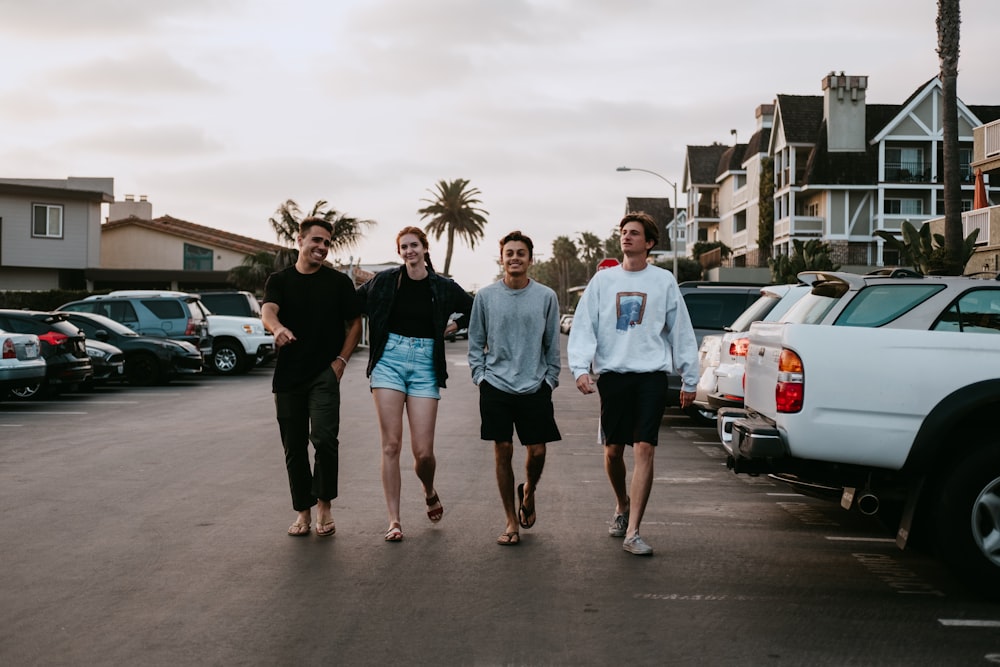 four person walking near vehicle