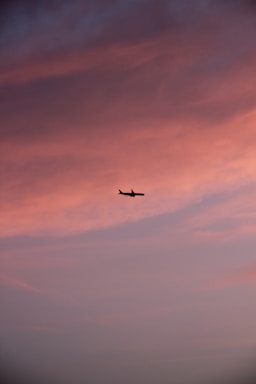 A sleek airplane silhouette against a sunset sky, symbolizing connection and flight.