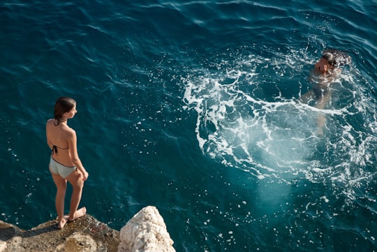 two women doing cliff diving in Rijeka Croatia