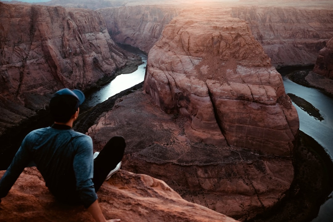 man sitting on Grand Canyon