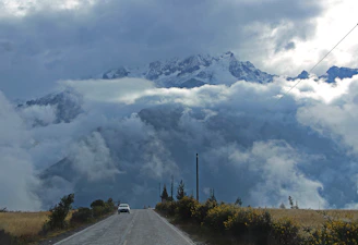 Scenic mountain landscape with a winding road symbolizing adventure and travel.