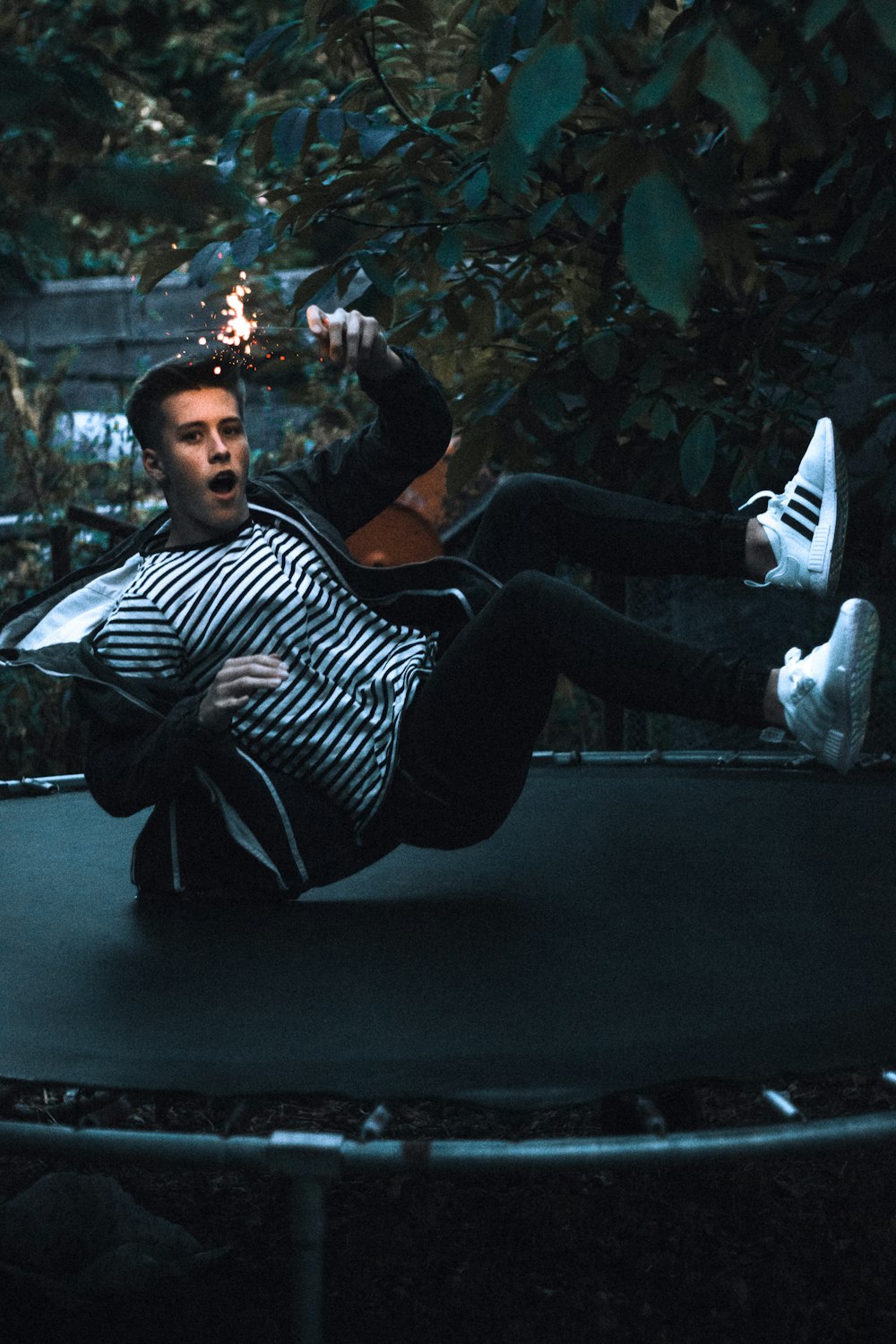 man jumping on black trampoline