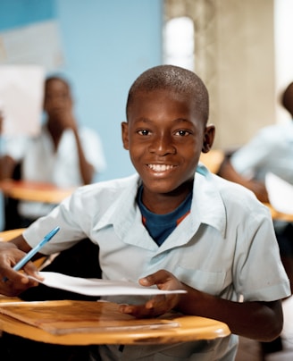 boy holding white paper