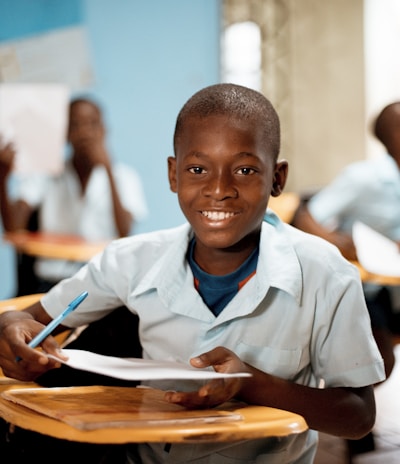 boy holding white paper